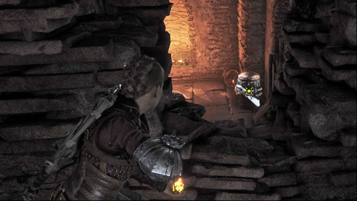 To progress you must climb up to a higher ledge and destroy the explosive tank through a hole in the wall (pictured above) - Plague Tale Requiem: Chapter 11, Explore the underground area - walkthrough - Chapter 11 - The Cradle of Centuries - A Plague Tale Requiem Guide, Walkthrough