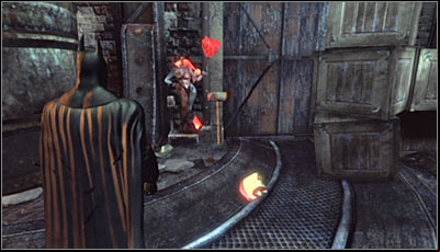Stand in front of one of Harley heads (no matter whether its already destroyed or not) and scan it together with the hammer beside it (screen above) - Riddles | Steel Mill - Steel Mill - Batman: Arkham City Game Guide