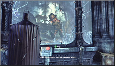 Find the puppet exhibit (screen above), approach it and press the red button to set it into motion - Riddles | Museum - Museum - Batman: Arkham City Game Guide