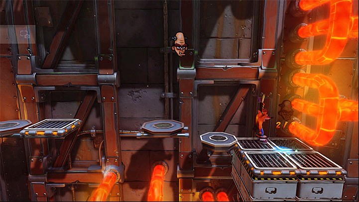 While exploring this part of the factory, stop on the larger ledge to the right, shown in the above screenshot - Heavy Machinery | Cortex Island | Levels - Crash Bandicoot - Cortex Island - Crash Bandicoot N. Sane Trilogy Game Guide