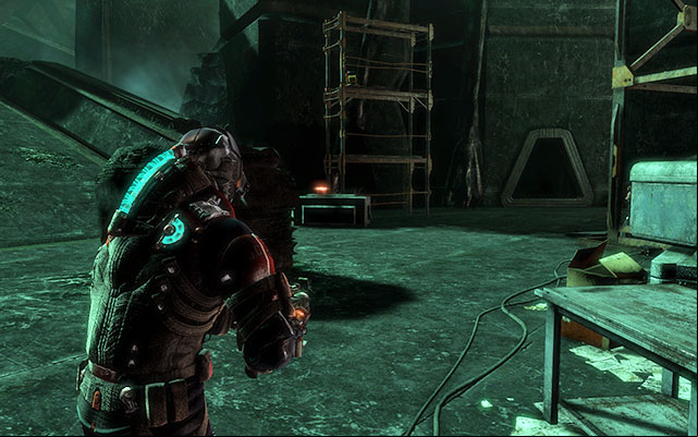 On the crate to the left, near the elevator, the workbench and the generator - Chapter 17 | Secrets - Secrets - Dead Space 3 Game Guide