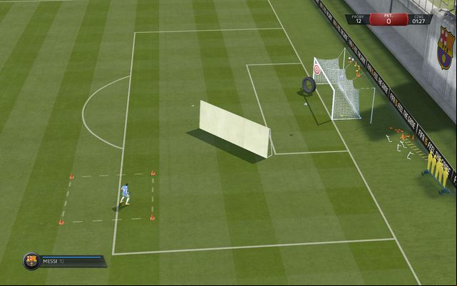 You need to use a chip shot, to lob the ball over a wall and hit one of the targets inside the goal - Advanced shooting - Skill games and practice - FIFA 15 - Game Guide and Walkthrough