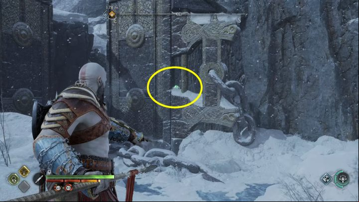 The bird is on a wall next to a large gate - God of War Ragnarok: Lake of Nine, Midgard - secrets, collectibles - Midgard - God of War Ragnarok Guide