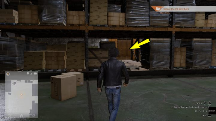 Walk between the cardboard boxes to the next room of the warehouse - Lost Judgment: Final Chapter, Darkest Before the Dawn - walkthrough - Main Storyline - Lost Judgment Guide