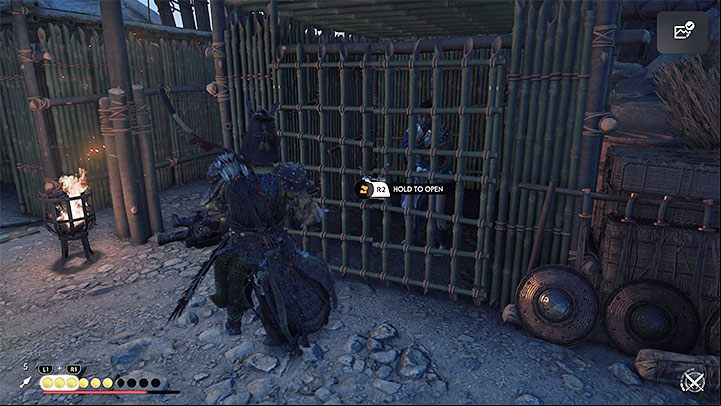 Cages with prisoners are always marked - you can hold the R2 trigger to open them or destroy the gates by attacking with your katana - Ghost of Tsushima Iki Island: The Lightning in the Storm - walkthrough - Main Missions - Ghost of Tsushima Guide, Walkthrough