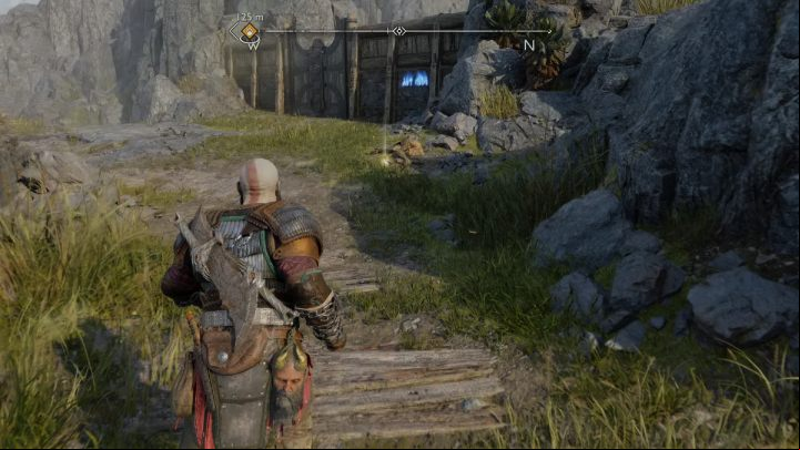 The runes are written on a wooden wall next to the gate to The Forge - God of War Ragnarok: The Forge, Svartalfheim - secrets, collectibles - Svartalfheim - God of War Ragnarok Guide