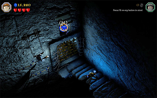 You need to hit the blue object above the gate, with the magic projectile - Stage 13 (Looking for Proof): Angmars Tomb | Walkthrough - Walkthrough - LEGO The Hobbit Game Guide & Walkthrough