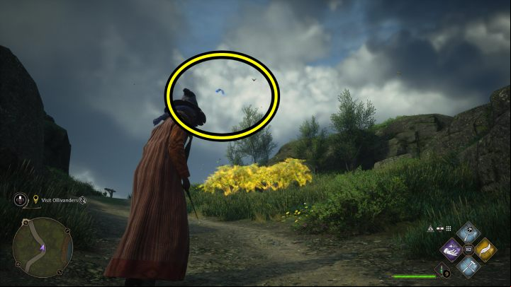 One of the Flying Guide Pages #18 (Hogsmeade) is flying by the path near the Dogweed and Deathcap shop - Hogwarts Legacy: Field Guide Pages Part 2 - Hogsmeade - Hogsmeade - Hogwarts Legacy Guide