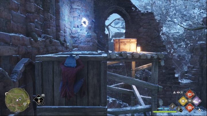 The last object is on a wooden platform, which you can access by climbing the nearby chests - Hogwarts Legacy: Ancient Magic Hotspots Part 1 - Highlands - Hogwarts Legacy Guide