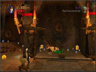 Destroy the wall to the left, take the LEGO piece and put it under the middle hole in the wall - Chapter 4 - The Well of Souls - part 1 - Riders of the Lost Ark - LEGO Indiana Jones: The Original Adventures - Game Guide and Walkthrough