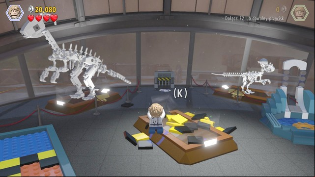 Use the scattered bricks to build an arm with a hammer and smash the glass pane with the velociraptor - Main Street Showdown | Jurassic World - walkthrough - Jurassic World - walkthrough - LEGO Jurassic World Game Guide & Walkthrough