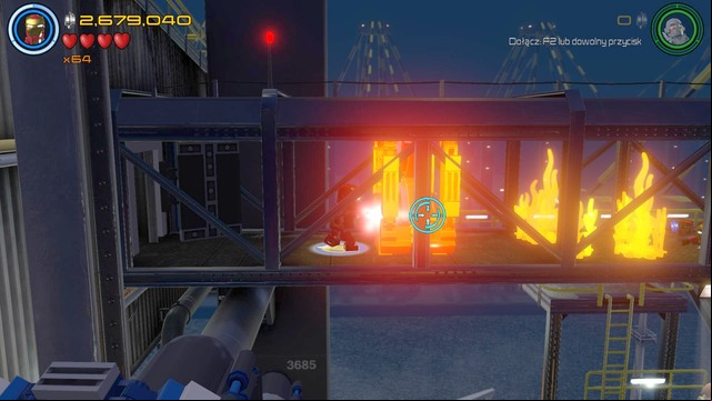 After walking to the previously opened room you must walk towards the golden barricade shown on the picture and burn it using Iron Mans lasers - Stan Lee / Red brick - Ready, A.I.M., Fire - secrets - LEGO Marvels Avengers - Game Guide and Walkthrough