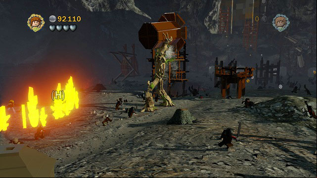 After getting through the wall of fire you will find a small fire with the chest inside - Osgiliath - Collectibles - LEGO The Lord of the Rings - Game Guide and Walkthrough
