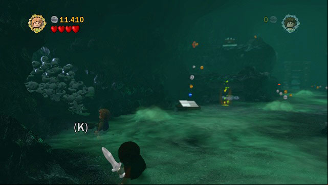 In the second big cave, on the left side there is some loose ground beside a pile of skulls - The Paths of the Dead - Collectibles - LEGO The Lord of the Rings - Game Guide and Walkthrough