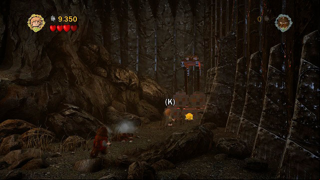 In the same location as Minikit #3, you need to head north to find a hook attached to boulders - The Black Gate - Collectibles - LEGO The Lord of the Rings - Game Guide and Walkthrough