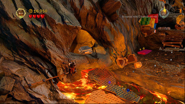 In the place where the rocks are falling down, as you're crossing the river of fire while holding onto the rail, you will see a cracked LEGO tile - Mount Doom - Collectibles - LEGO The Lord of the Rings - Game Guide and Walkthrough