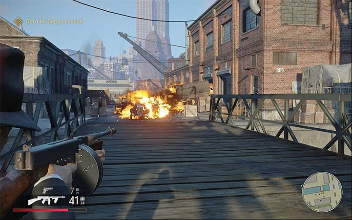 When you get closer to the bridge, you will have an excellent opportunity to hit barrels and blow up vehicles - Mafia Definitive Edition: You Lucky Bastard - walkthrough - Walkthrough - Mafia Definitive Edition Guide, Walkthrough