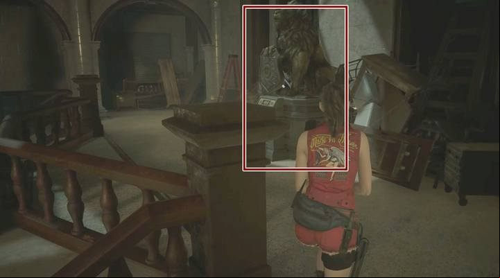 The statue at the top of the stairs in the main hall. - Collect 3 medallions task | Police station in Resident Evil 2 - Walkthrough - Resident Evil 2 Guide