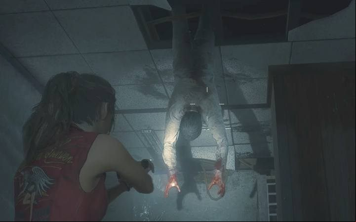 Knock the hanging zombie down on the floor - when it wakes up, it wont let you leave the room quietly. - Collect 3 medallions task | Police station in Resident Evil 2 - Walkthrough - Resident Evil 2 Guide