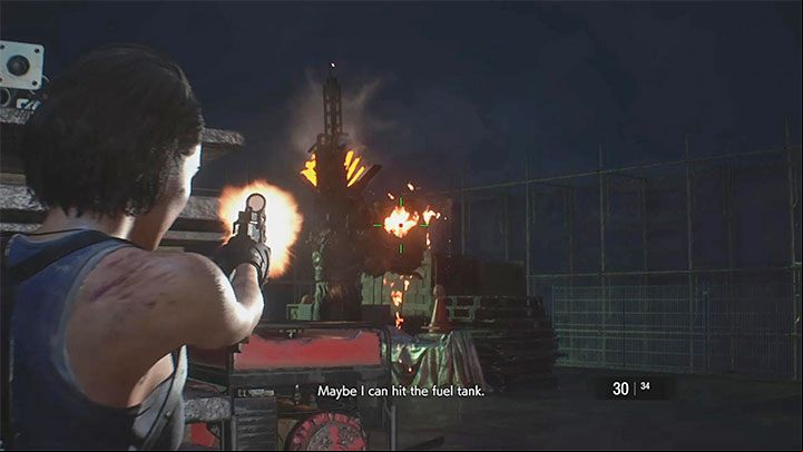 The key to winning the first part of this battle is shooting at the fuel tank on Nemesis back - Resident Evil 3: Demolition site walkthrough - Story walkthrough - Resident Evil 3 Guide