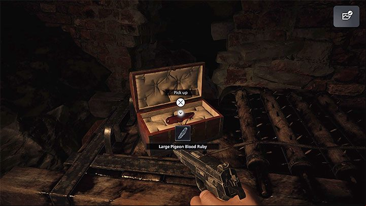 The protagonist will eventually get to a small box which contains the ruby - Resident Evil Village: Necklace with Two Holes - how to complete? - Puzzle solutions - Resident Evil Village Guide