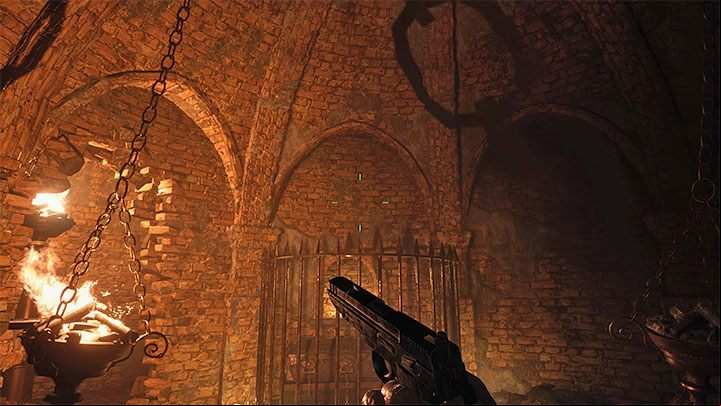 Tearing down the wall will allow you to reach the loot, but more importantly, you can now light up one of the braziers that hang from the chains - Resident Evil Village: Treasure Map - Where is the treasure? - Puzzle solutions - Resident Evil Village Guide
