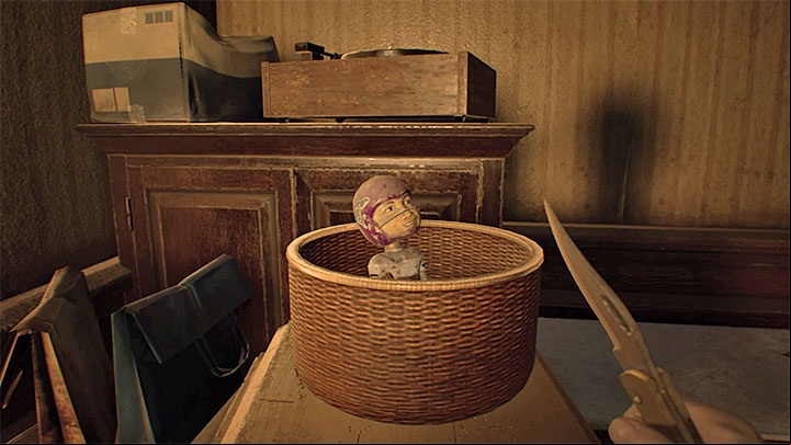 One of the figures (it looks like a bobblehead) - Resident Evil 7: Trophy/Achievement Guide - Trophy Guide / Achievement Guide - Resident Evil 7 Guide, Walkthrough