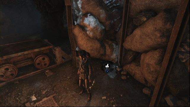 Next to the tracks and the cart, at the rocks, before the elevator shaft entrance - Rise of the Tomb Raider: Survival Caches, Abandoned Mine secrets, locations - Abandoned Mine - Rise of the Tomb Raider Guide