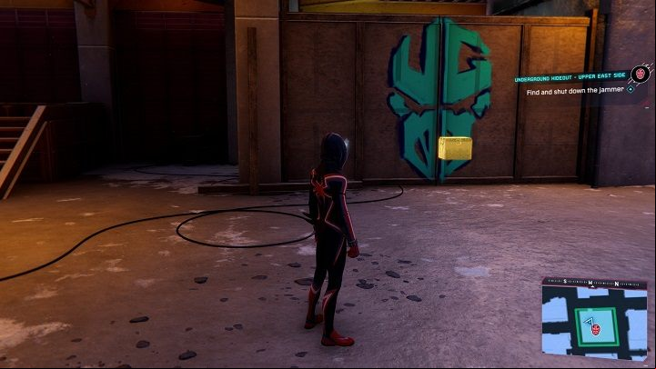 5) The cache in the Underground Hideout is hidden behind the wall with the logo - approach it and press L1 square to get inside - Spider-Man Miles Morales: All Underground Caches - list - Collectibles - Spider-Man Miles Morales Guide