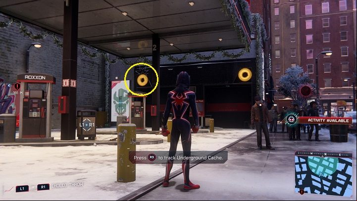 2) The box in the center of Greenwich is in the garage of the Roxxon station - Spider-Man Miles Morales: All Underground Caches - list - Collectibles - Spider-Man Miles Morales Guide