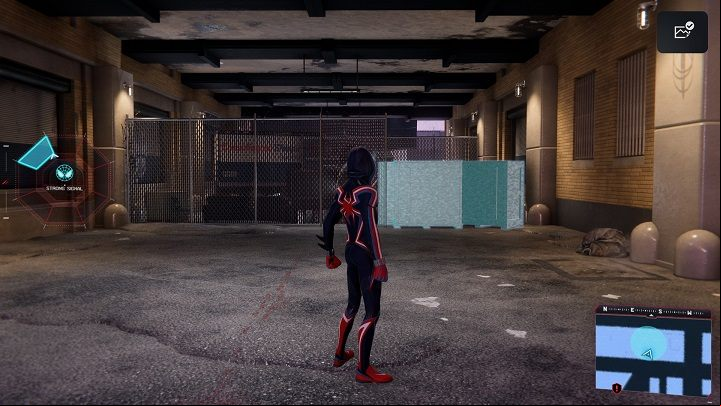 3) Smash the wooden boxes under the building which borders the Financial District to get to the cache - Spider-Man Miles Morales: All Underground Caches - list - Collectibles - Spider-Man Miles Morales Guide