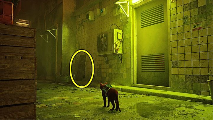 Seamus' flat is in the yellow-lit building on the right - Stray: Seamus flat - where is it in the Slums? - FAQ - Stray Guide, Walkthrough