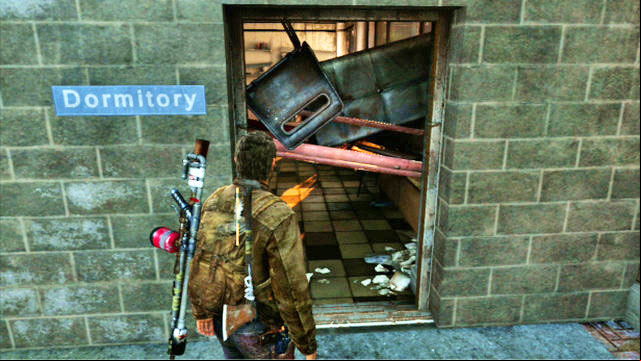 The path will take you to a locked gate, which you can get around by squeezing through the barricaded door to the right - The Last of Us: Go Big Horns! The University Walkthrough - The University - The Last of Us Guide