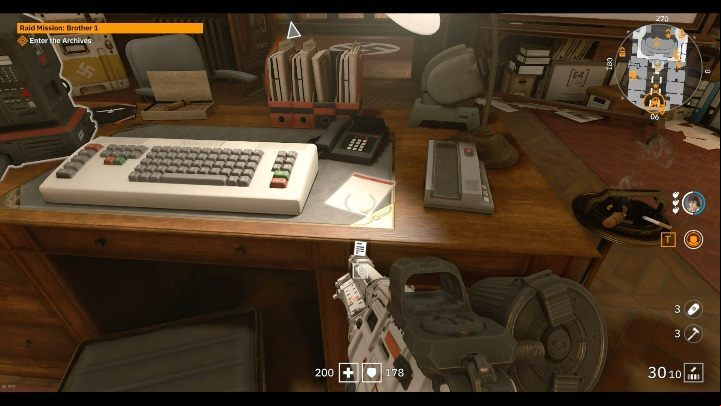On a large wooden desk there is a massive computer and an equally large keyboard - Secrets and collectibles in Brother 1 | Wolfenstein Youngblood - Collectibles and secrets - Wolfenstein Youngblood Guide