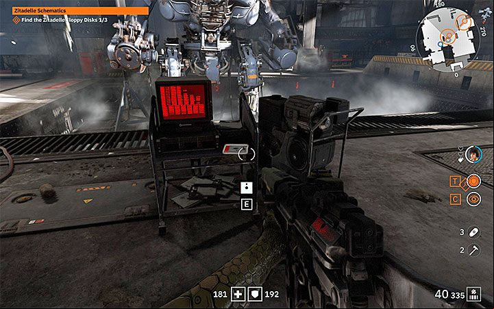 The third floppy disk (Zitadelle Schematics #3) lies on a wheeled table in front of a big, inactive mech - Zitadelle Schematics | Wolfenstein Youngblood Walkthrough - Side missions - Wolfenstein Youngblood Guide